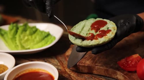 Preparing Burger With Vegetables and Ketchup