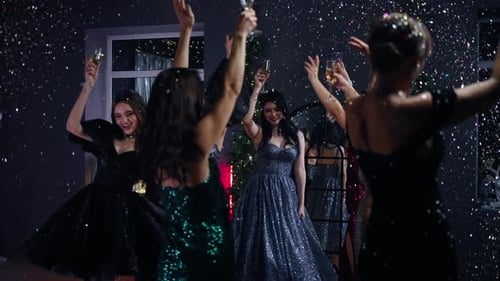 Group of Young Adults Celebrating With Confetti and Dancing