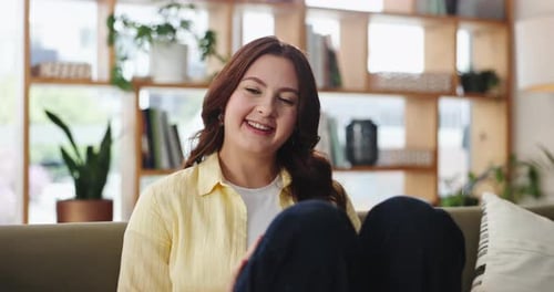 Smiling Woman on Couch in Living Room