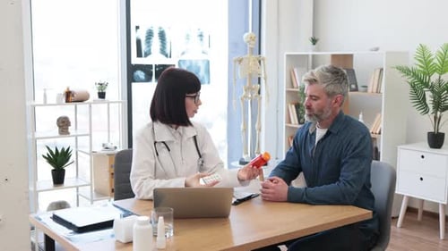 Doctor Explains Medication to Patient in Office