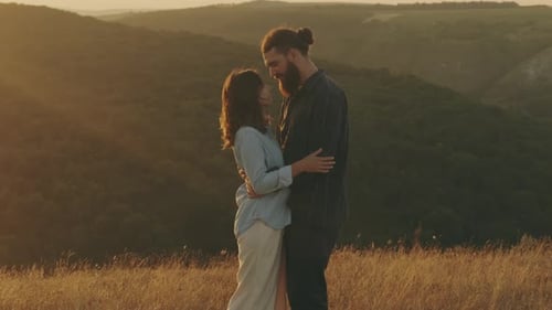 Couple Embracing Tenderly in Golden Field at Sunset