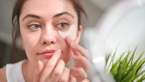 Woman Applying Under Eye Mask for Skincare