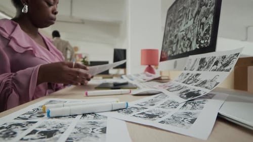 Young Woman Drawing Comic Book in Office