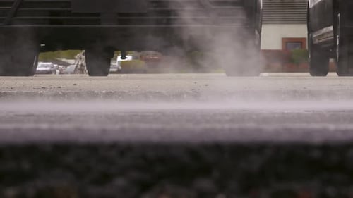 Asphalt Paving. Road Roller Drives Over Hot, Steaming, Freshly Layed Asphalt.