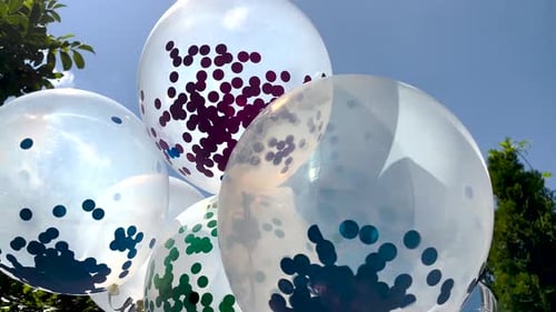 Confetti Balloons Floating in Daylight