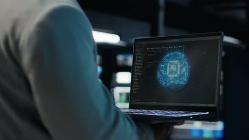 Server Room Admin Using Laptop to Do Infrastructure AI Automatization