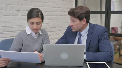 Business Meeting in Office Discussing Documents