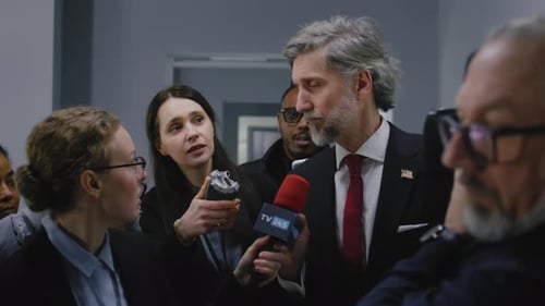 Confident Politician Gives Interview for Media Walking in Parliament Hallway