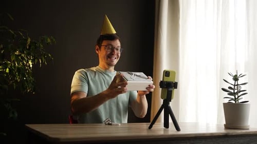 Man with Party Hat Celebrates Birthday with Video Call