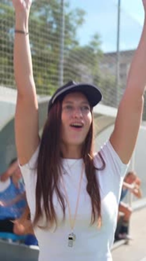 Enthusiastic Female Sports Team Celebrates Victory with Coach