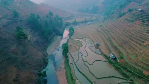 Rice terraces contoured onto the Vietnamese landscape. Lush valley of patterns of colorful paddy fie