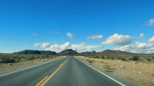 Desert Highway Stretching Into the Distance A Vast Open Road Slicing Through the Desert Landscape