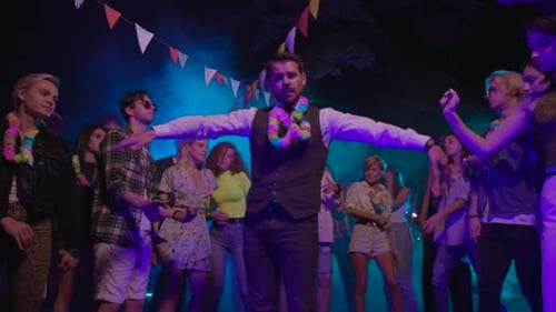 Happy Group Dances Together at Outdoor Celebration