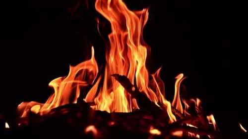 Night fireplace glowing. Bonfire flame heating in slow motion.