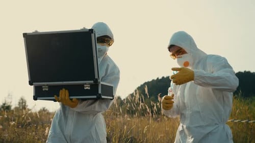 Scientists Wearing Protective Equipment Engaged in Conducting Field Research and Analysis