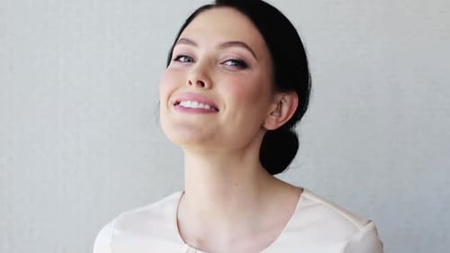 Attractive woman smiling, laughing and styling her hair