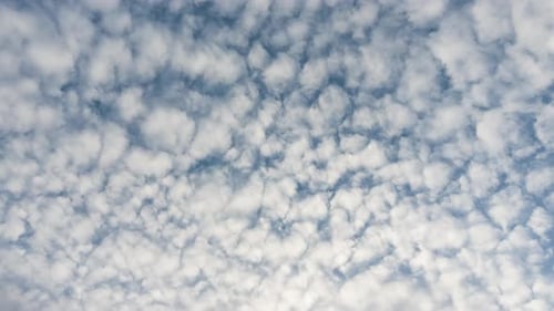 Blue Sky with White Clouds and Sun. Puffy Fluffy White Clouds Moving Fast. Cumulus Cloudscape