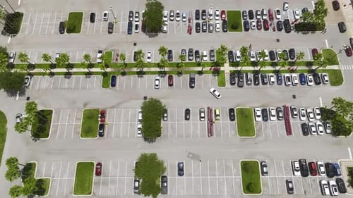Aerial View of Large Parking Lot with Many Parked Colorful Cars