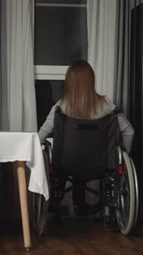 Housewife Moves Wheelchair Closer to Look Out Small Window