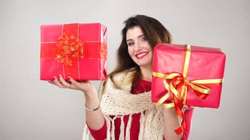 Smiling Woman Holding Christmas Gifts Indoors