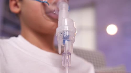 Child Receiving Breathing Treatment with Oxygen Mask