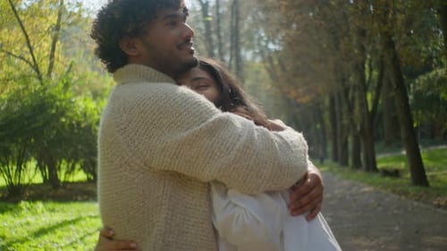 Romantic Couple Embrace in Sun Drenched Park