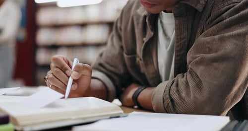Student, writing and books with hands of man in library for knowledge, education and college thesis