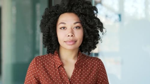 Webcam view. Young african american female employee watching video call training looking at camera