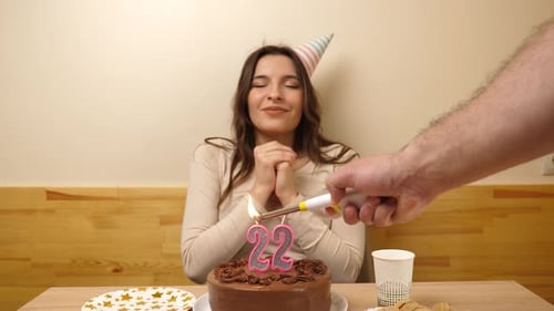 Young Woman Celebrating Twenty-Second Birthday with Chocolate Cake