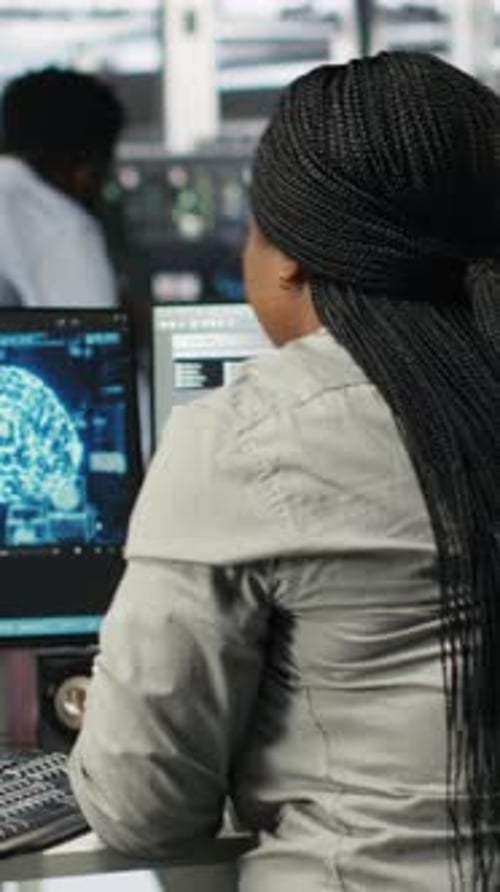 Woman Working at Computer with Brain Scan Imagery