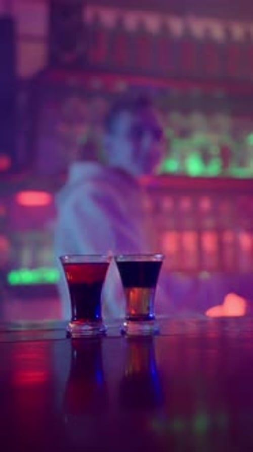 Glass of Alcoholic Drink on Fire on a Bar Counter Closeup in a Nightclub