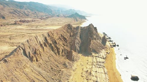 Rocky Coastal Cliffs and Ocean Waves Aerial View