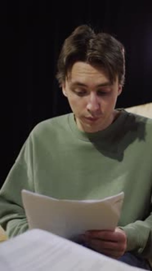 Actor Reading Play Script and Talking with Scene Partner on Theatre Rehearsal