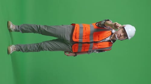 Full Body Of Asian Male Engineer Disapproving With No Index Finger Sign On Green Screen