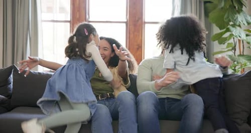 Happy Family Playing and Laughing on Couch