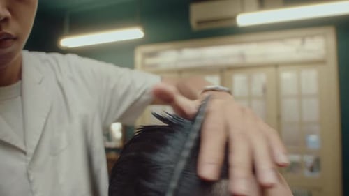 Barber Using Shears and Comb for Giving a Haircut