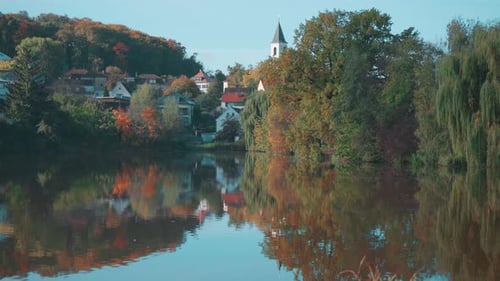 St. Sebastian's and Fabian's Church in Prague Reflecting on a Tranquil Lakeside View