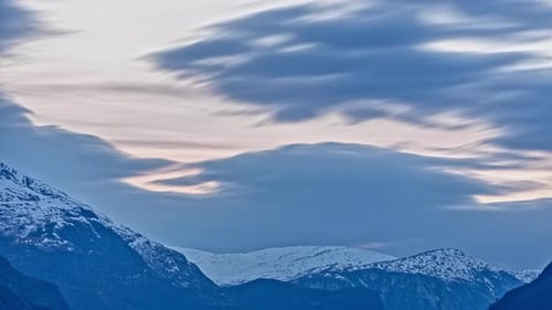 Timelapse video of beautiful snowcapped mountains and beautiful moving clouds in Aurland, Sogn And F