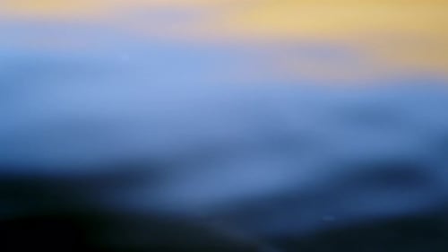 Real of water drop falls into water and diverging circles of water with smoot color background in st