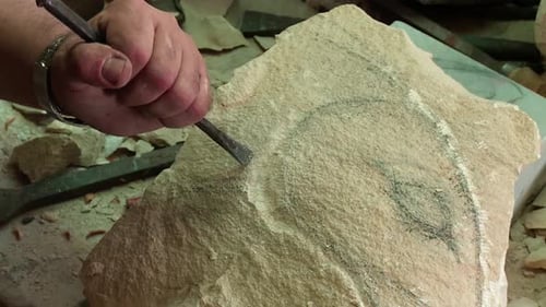 shaping stone, sculptor works on stone