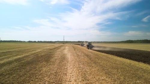 Tractors plowing the field in Ukraine