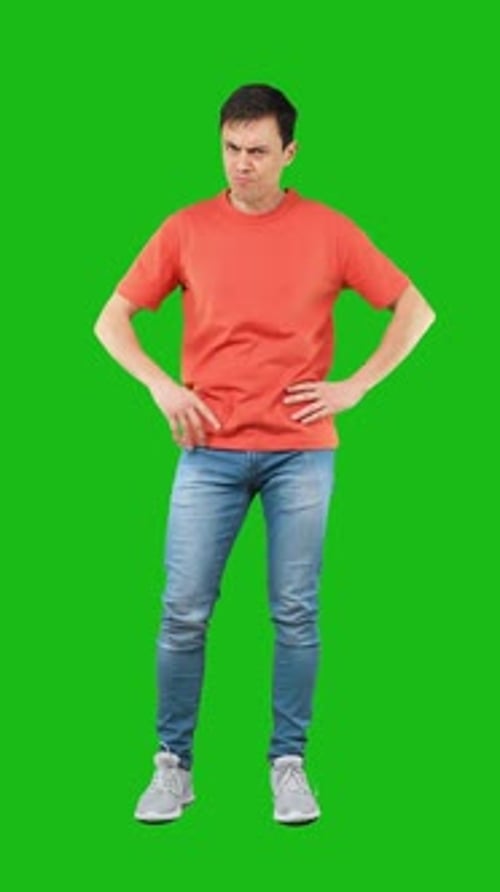 Irritate Frowning Male Standing with Hands on Waist in Studio