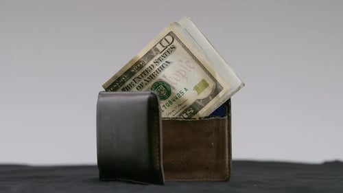 Wallet filled with cash and credit cards