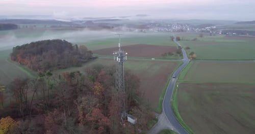 Cellular tower on countryside of Germany with foggy weather, telecommunication