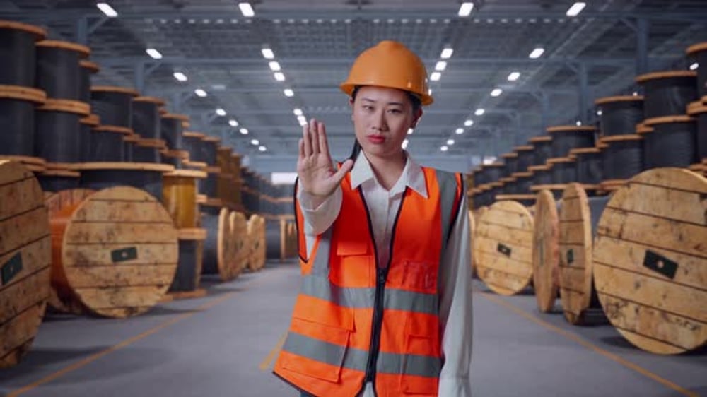 Asian Female Engineer Disapproving With No Hand Sign in Warehouse ...