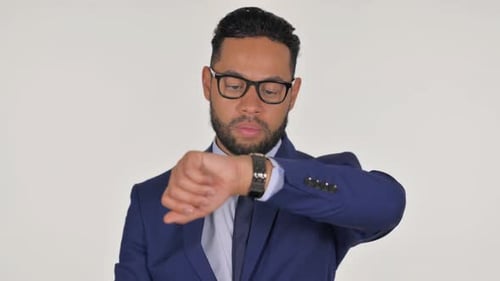 Portrait of Waiting Young Hispanic Businessman Checking Time on White Background