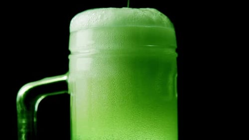 Green Beer with Foam and Bubbles in the Pint