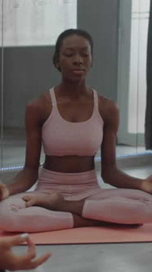 Woman Meditating Comfortably on Yoga Mat Indoors