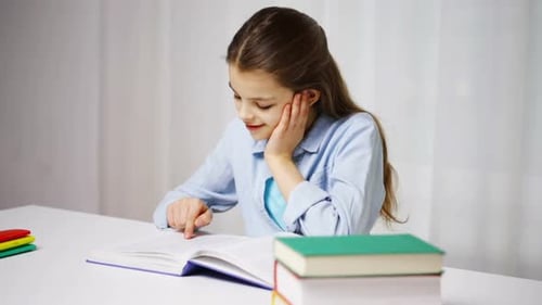 Happy School Girl Reading Book or Textbook at Home Book