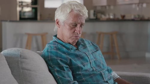 Grandfather and Grandson Laughing and Embracing Indoors